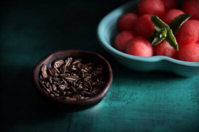 CO_New Çekirdeği Oyalı watermelon seeds in a bowl along with fruit scooped in another bowl photographed together