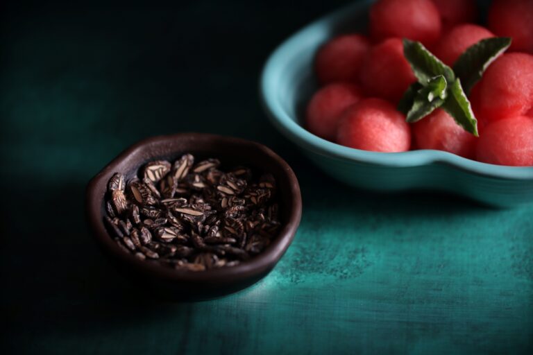 Çekirdeği Oyalı watermelon seeds in a bowl along with fruit scooped in another bowl photographed together