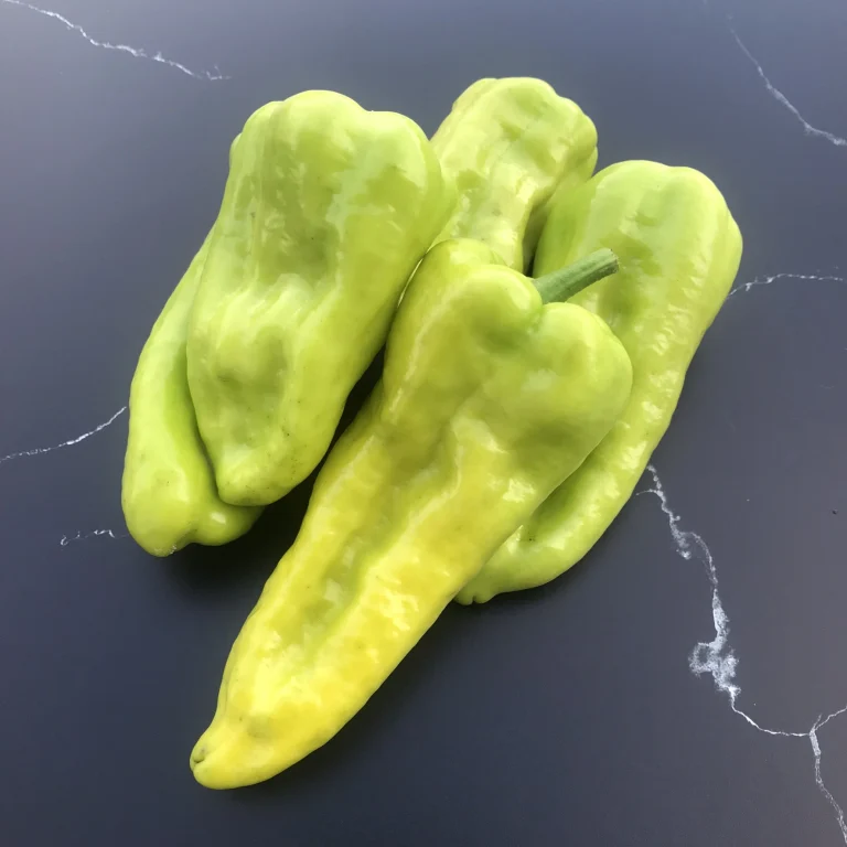 Five Kale hot peppers on granite surface