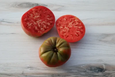 German Pink Three pink tomatoes, two halved, one whole.