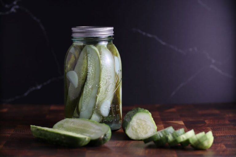 Sliced Boston Pickling cucumber photographed in a pickling jar.