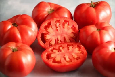 Ege Pembesi 50-1 Fresh red Ege Pembesi tomatoes, one sliced open.