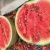 White-seeded Ayas watermelon cut in half and photographed on kitchen counter.