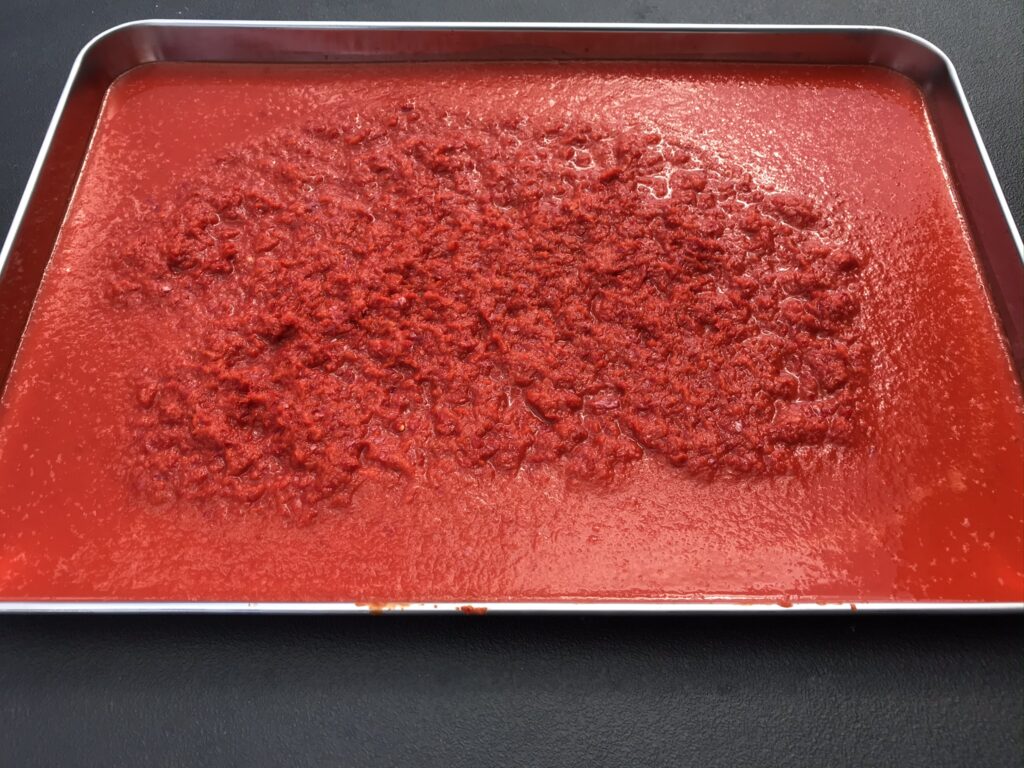 Final stage of making Turkish Pepper Paste is to transfer the pulp into a shallow tray with a large surface area